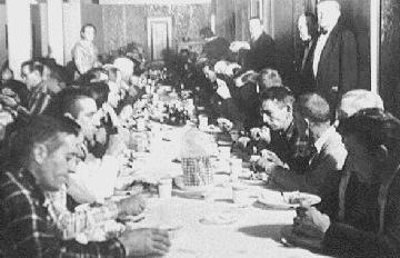 homeless men eating at a table